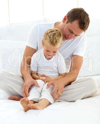 Attentive dad hugging his son