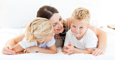 Cute blond boy with his sister and his mother