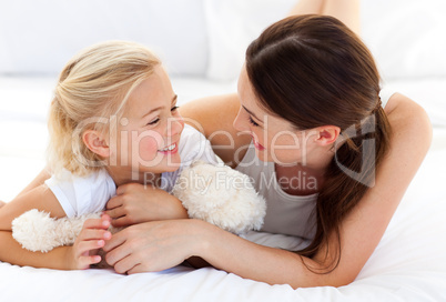 Happy mother and her daughter playing together