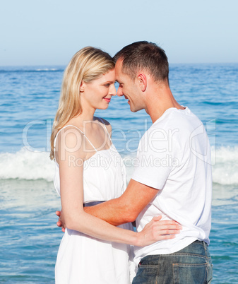 Loving couple cuddling at the beach