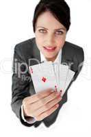 Charming businesswoman holding a full deck aces