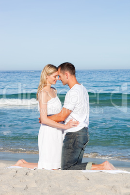 Romantic couple hugging on the sand