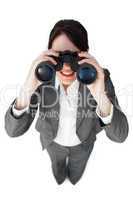 Self-assured businesswoman looking through binoculars