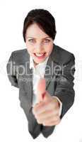 Radiant businesswoman with thumb up