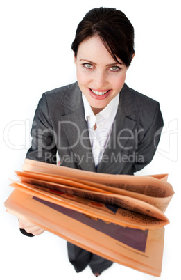 Assertive businesswoman reading a newspaper