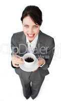 Sparkling businesswoman drinking a cup of coffee