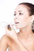 woman aplying her lipstick