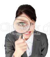 Close-up of a businesswoman looking through magnifying glass