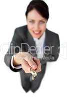 Smiling businesswoman holding a key