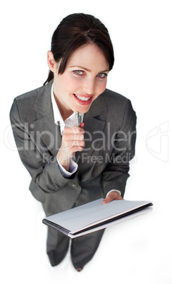 Smiling young businesswoman taking notes