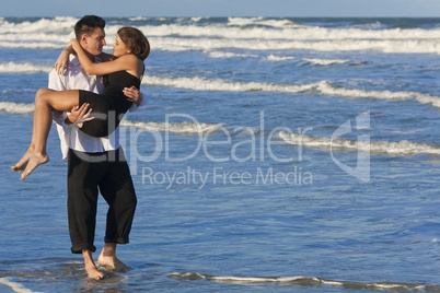Man Carrying Woman in Romantic Embrace On Beach