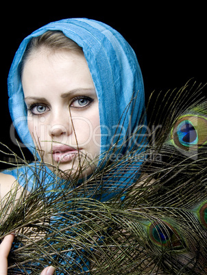 very beautiful woman  a scarf and with a feather in a hand