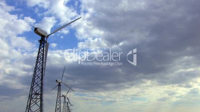 HD group of spinning wind turbines on the background of cloudscape, closeup