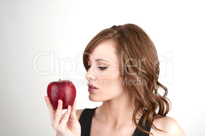 Beautiful girl examining an apple