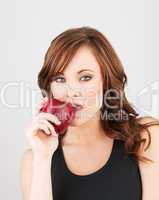Beautiful girl biting into a red apple