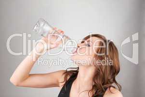 Beautiful young girl drinking water
