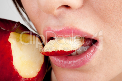 Girl's mouth biting apple