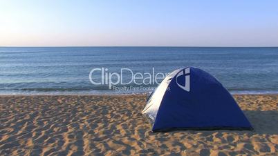 HD Tent on a sandy beach with sea and skyline background