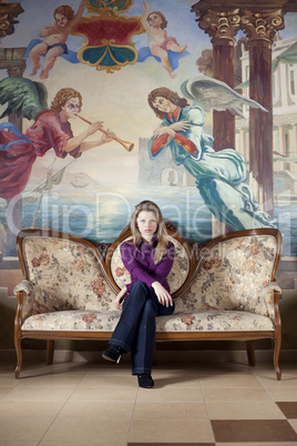 Blond woman waiting on luxury sofa