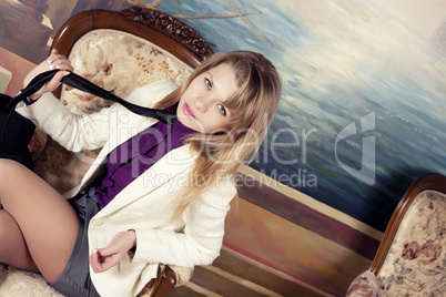 Blond woman playing with tie