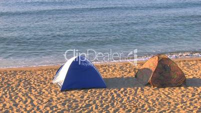 HD Two tents on a sandy beach early in the morning