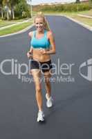 Beautiful Blond Woman Running and Listening to MP3 Player