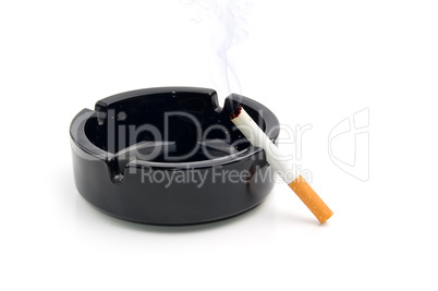 cigarette in a black ashtray