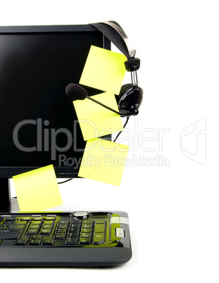 computer with VOIP headset and sticky notes