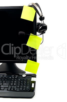 computer with VOIP headset and sticky notes
