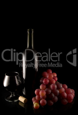 wine and red grape on black