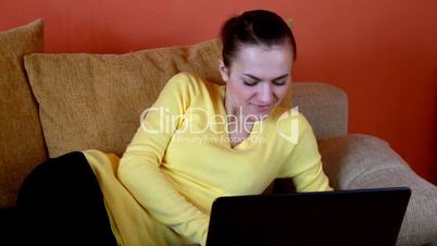woman on bed with laptop computer