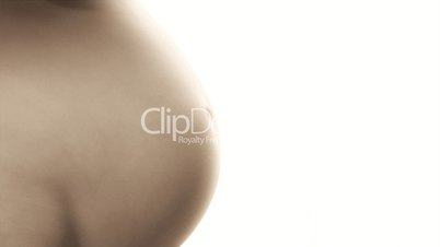 Close up of belly of nude pregnant woman