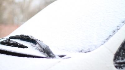 Automobile brushes clean glass from snow.