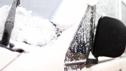 Automobile brushes clean glass from snow.