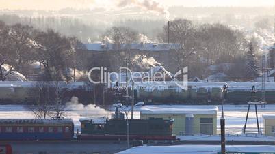 Train departure on rail station in sunny winter