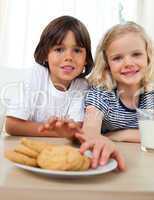 Cute siblings eating biscuits