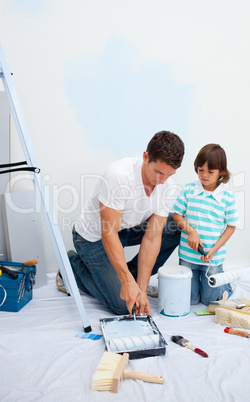 Lively Father and his son painting in their new house