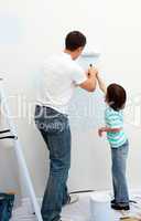 Caring father teaching his son how to paint