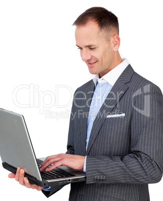 Smiling businessman using a laptop