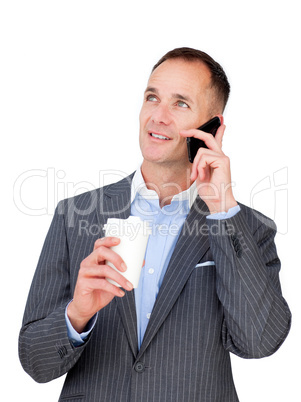 Charming businessman on phone holding a drinking cup
