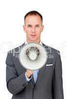 Serious businessman holding a megaphone