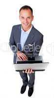Cheerful businessman using a laptop