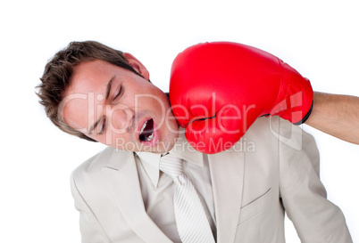 Close-up of a businessman being hit with a boxing glove