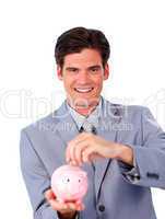 Charismatic businessman saving money in a piggy-bank