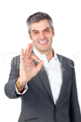 Smiling mature businessman showing OK sign