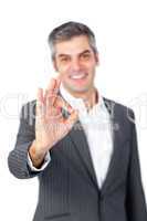 Smiling mature businessman showing OK sign