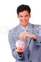 Cheerful businessman saving money in a piggy-bank