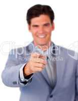 Positive businessman pointing at the camera