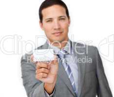 Confident male executive holding a white card