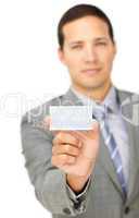 Composed young businessman holding a white card
